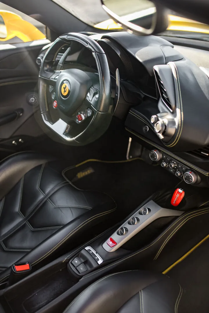 Abitacolo della Ferrari gialla con il volante e il tunnel centrale